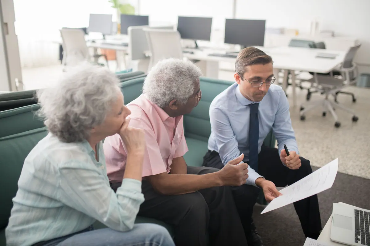 A solicitor going through a document with two clients